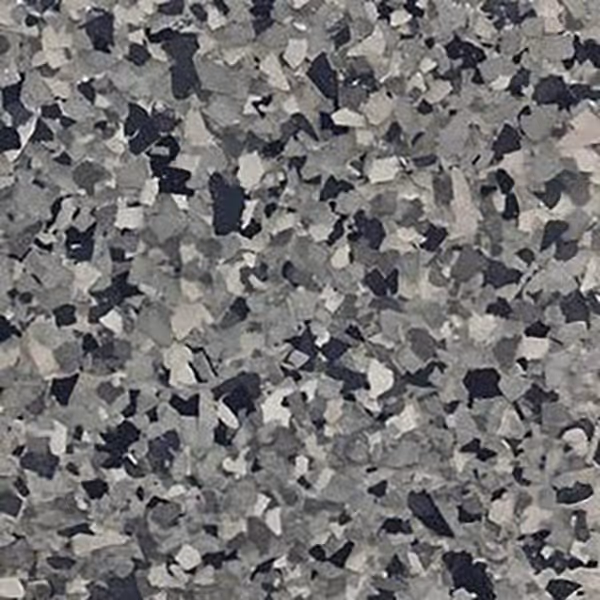 Close-up of multi-shade gray epoxy flake flooring with irregular, scattered chip patterns.