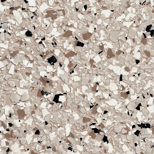 Close-up of epoxy flooring with beige, white, and black decorative flakes.