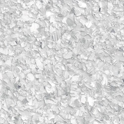 Close-up view of white flaky mineral crystals densely covering the surface.