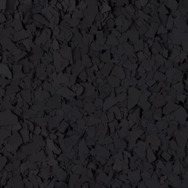 Close-up of irregularly shaped black rubber flakes spread densely.