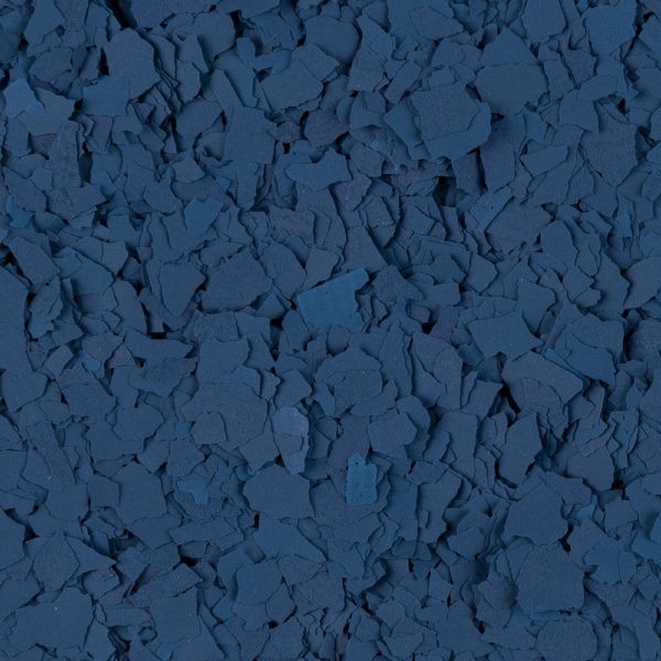 Close-up of irregularly shaped dark blue flakes densely layered together.