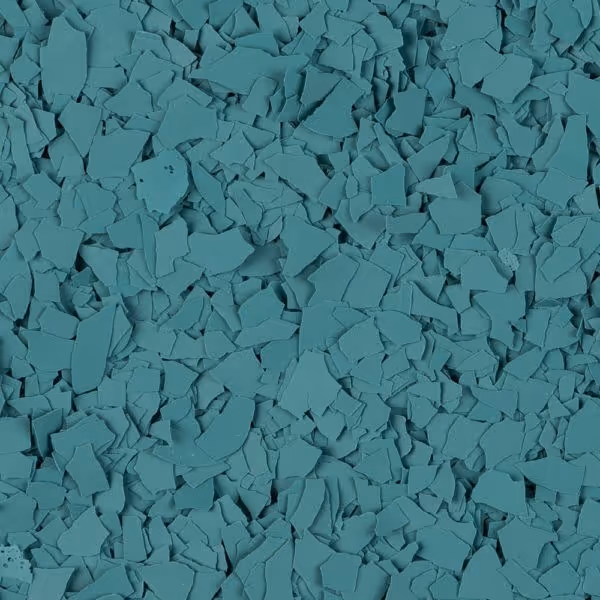 Close-up of numerous small, irregularly shaped blue flakes scattered densely.