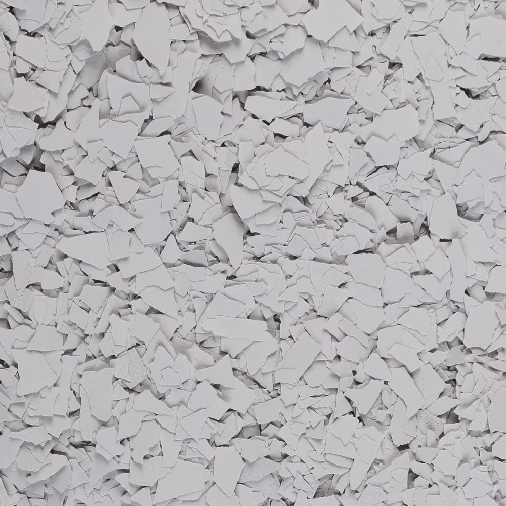 Close-up of light grey, irregularly shaped paint flakes scattered densely.