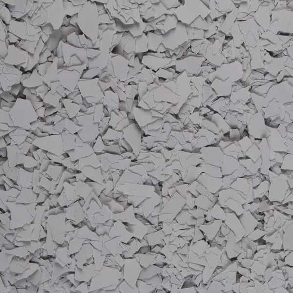 Close-up of numerous layered grey paint flakes scattered densely.