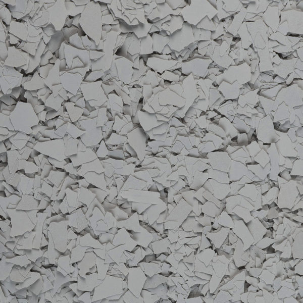 Close-up of numerous layered grey paint flakes scattered densely.