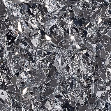 Close-up of reflective silver flakes with irregular shapes scattered densely.