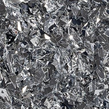 Close-up of reflective silver flakes with irregular shapes scattered densely.