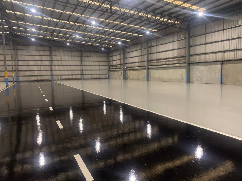 Warehouse epoxy floor with black and gray light reflective floor coating