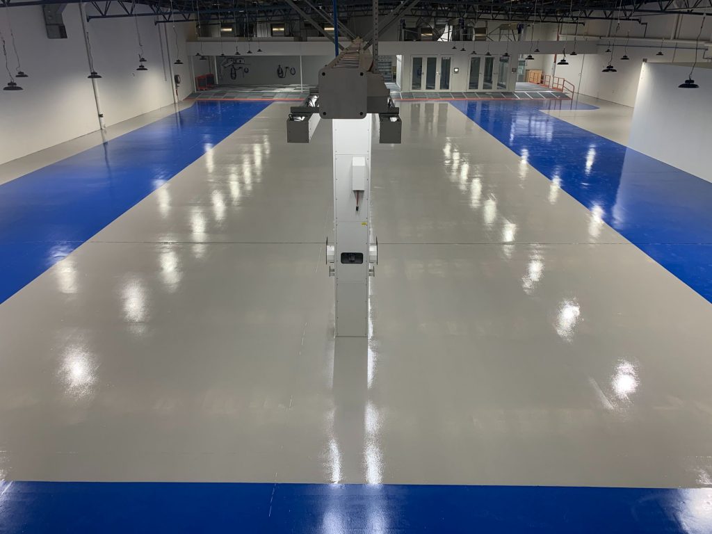 Industrial gray epoxy floor with blue safety areas melbourne vic
