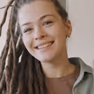 Young girl with dreadlocks making presentation sitting table class