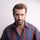 Man in red and blue stripes button up shirt