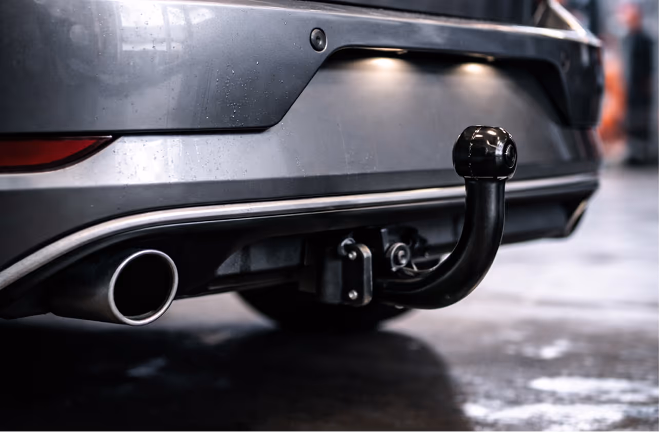 Een monteur controleert de onderkant van een auto tijdens de APK keuring