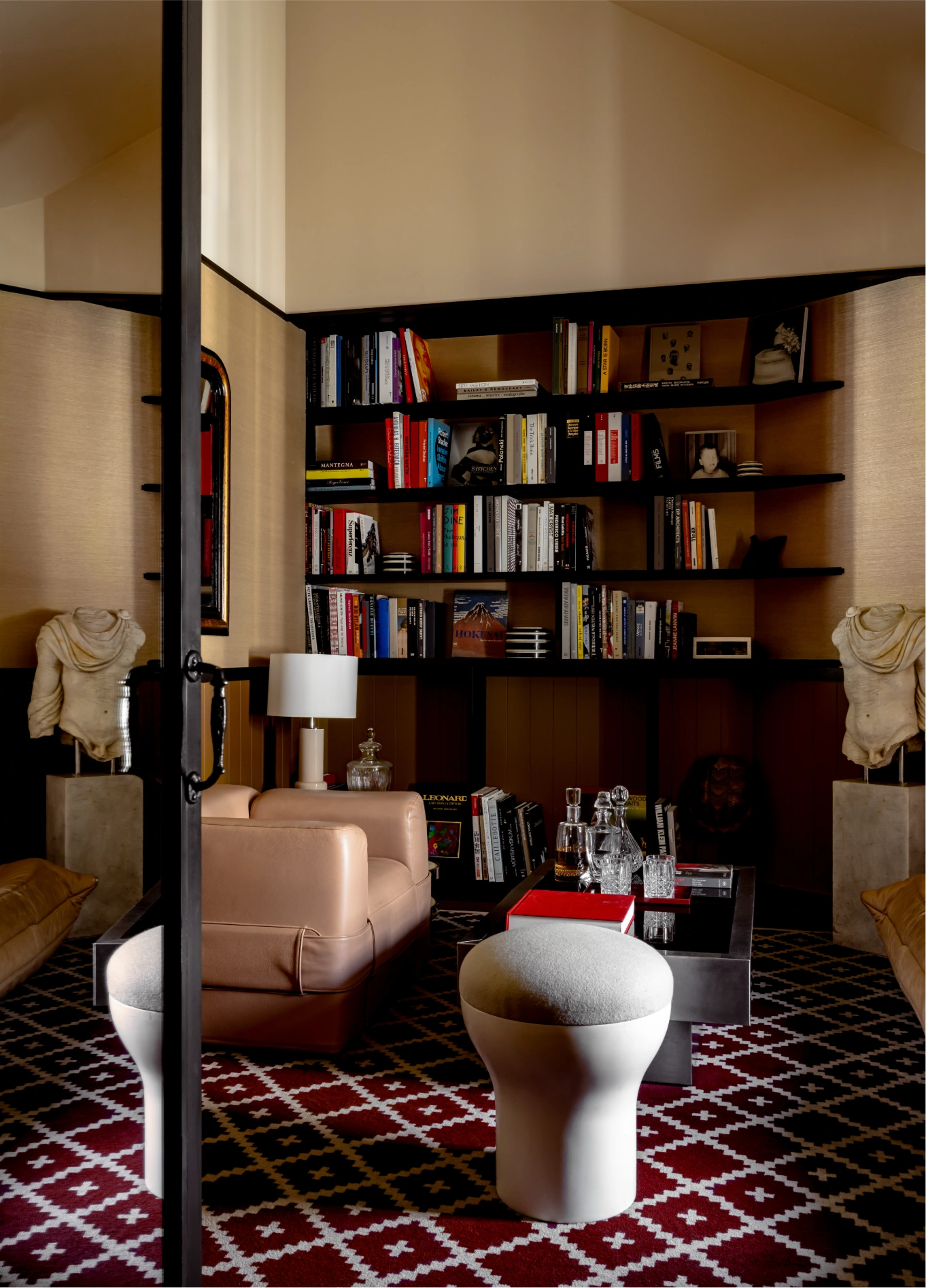 Bedroom with built-in bookshelf and patterned rug at Experimental Marais, Paris