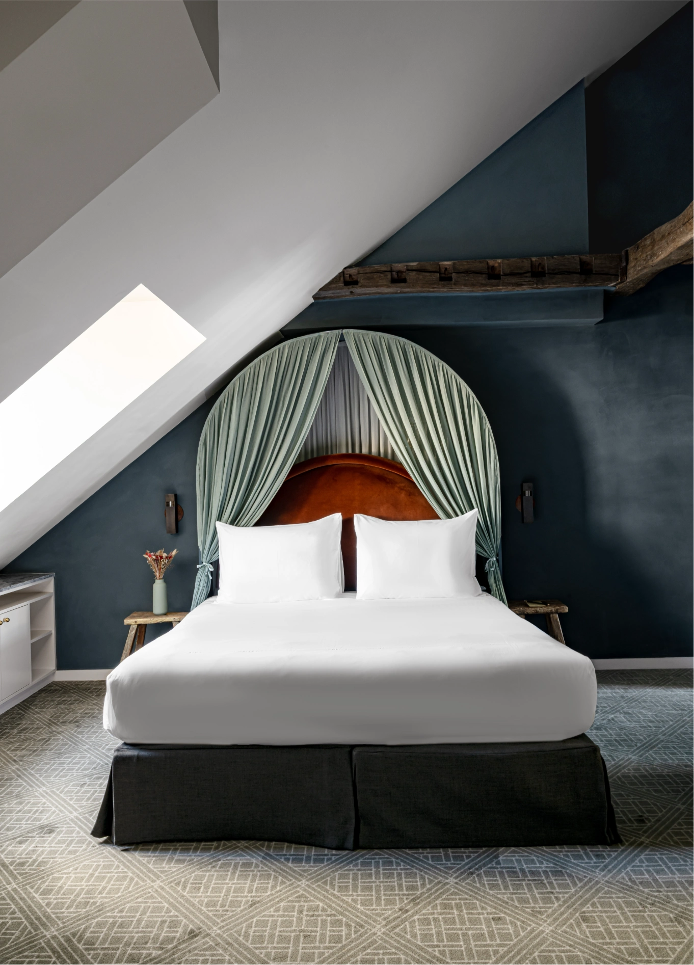 Attic bedroom with green tufted headboard and white bed at Grands Boulevards Experimental, Paris 2