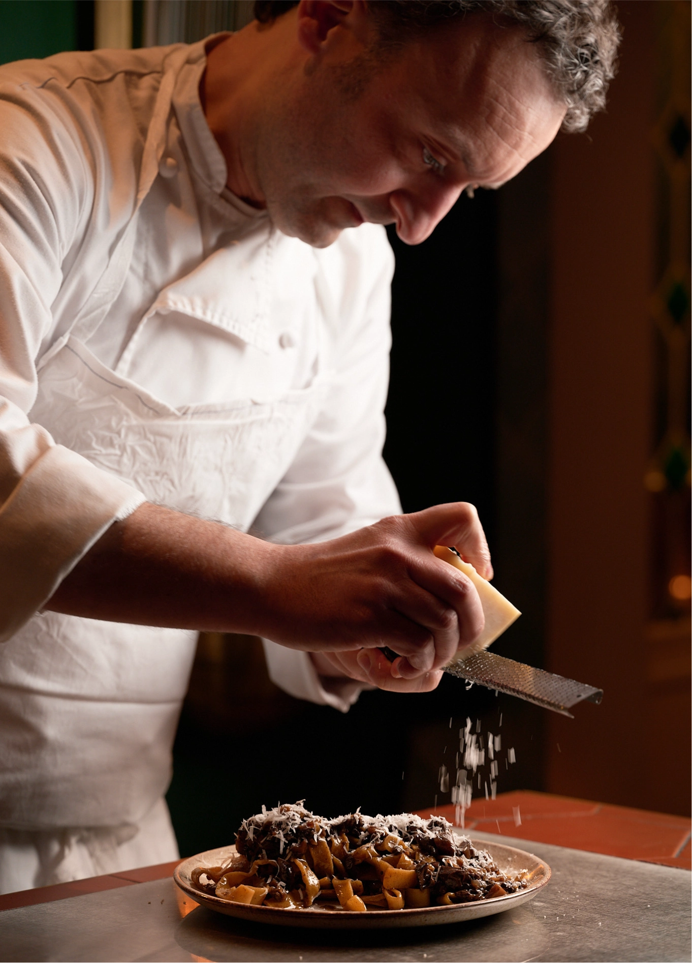 Chef plating an upscale dish at Restaurant des Grands Boulevards, Paris