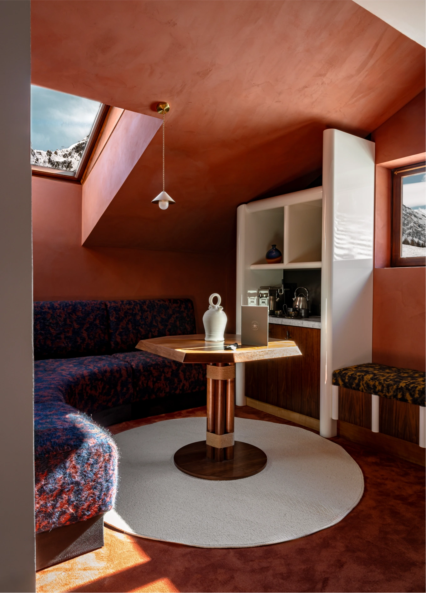 Cosy attic bedroom with pink sofa at Experimental Chalet, Val d'Isère, French Alps