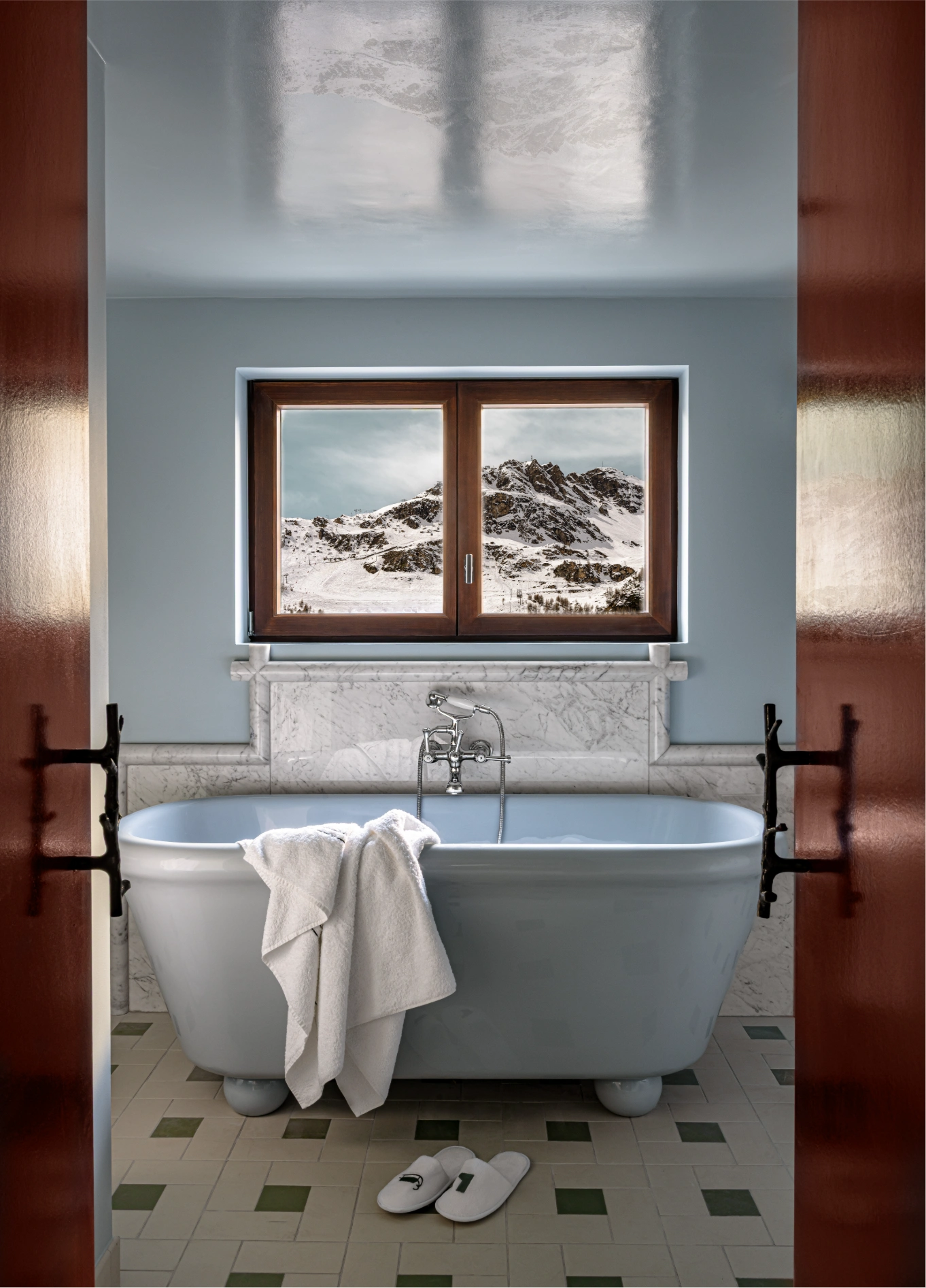 Bathroom with freestanding bathtub and vintage tiles at Experimental Chalet, Val d'Isère