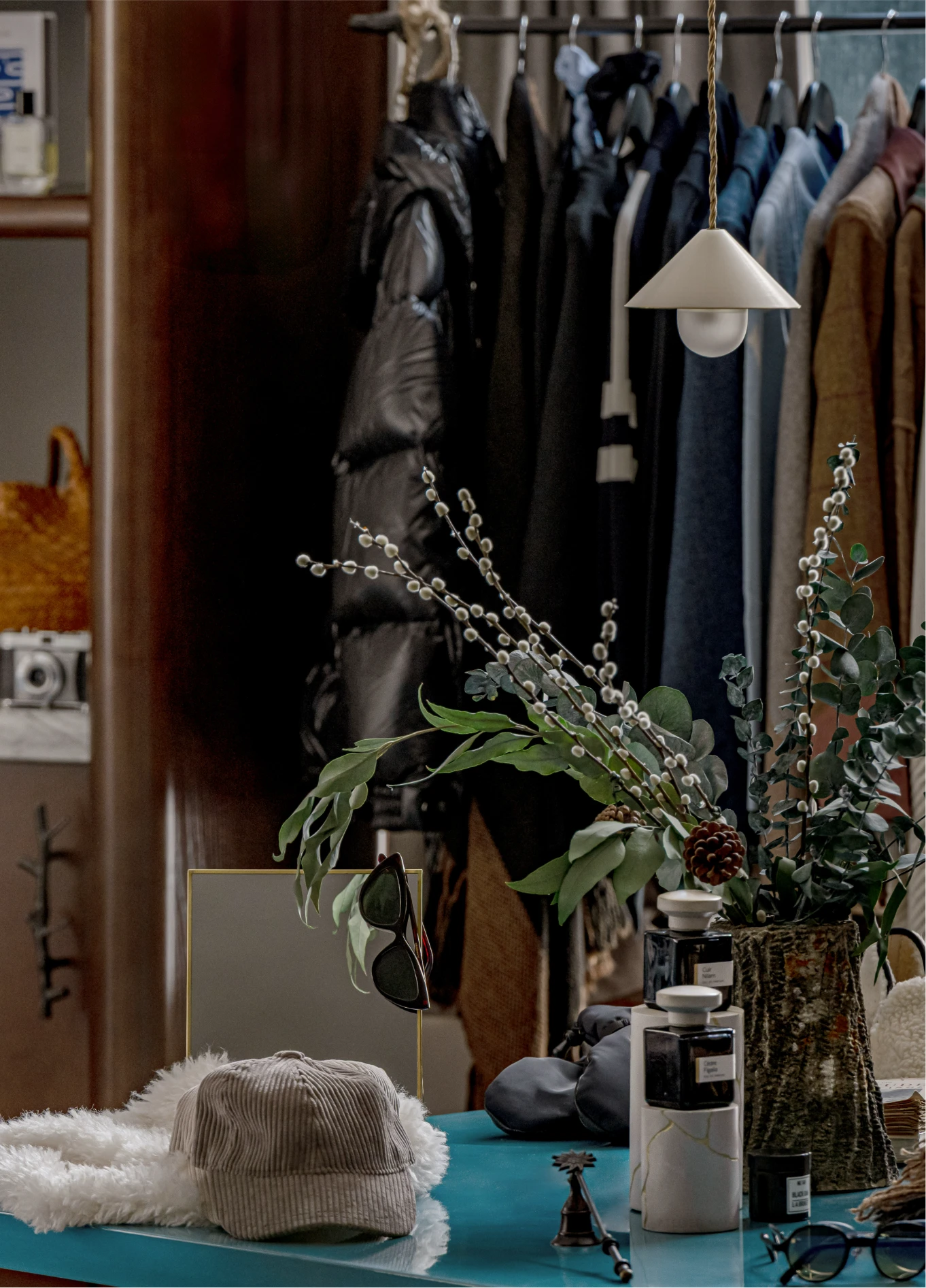 Clothing rack with plants and accessories at Experimental Chalet boutique, Val d'Isère