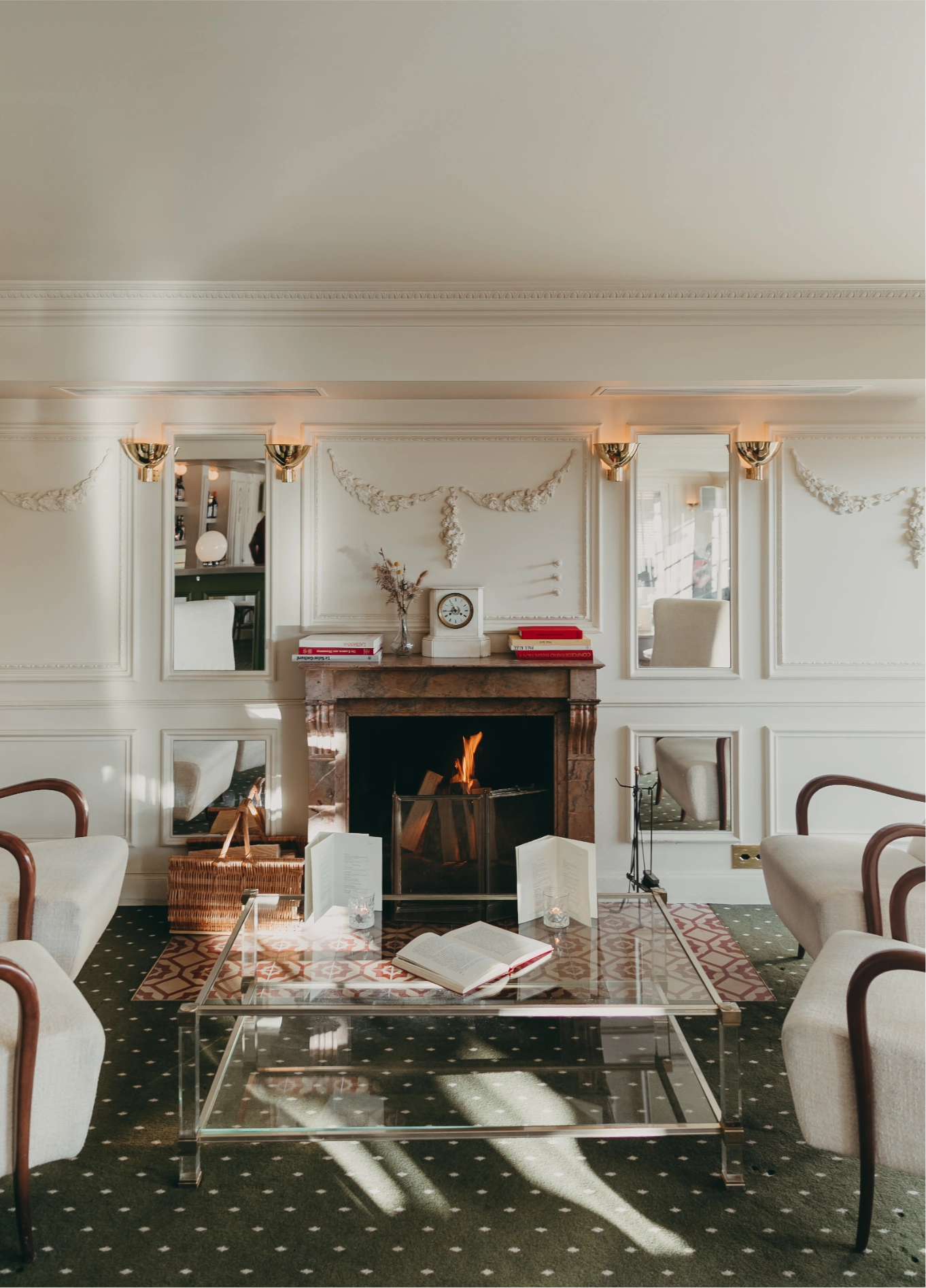 Cosy lounge with fireplace and white sofas at Experimental Cocktail Club, Verbier, Swiss Alps
