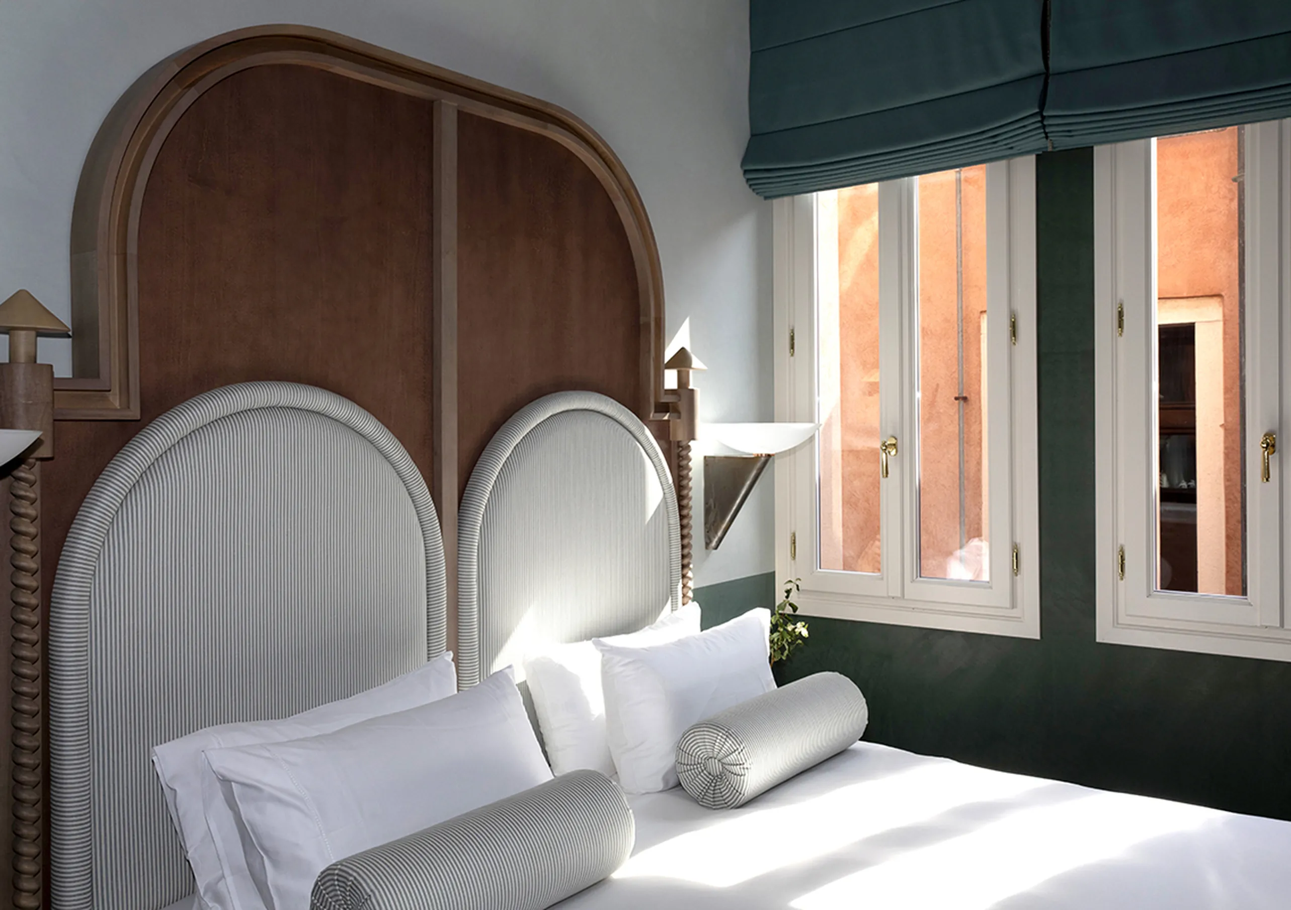 Il Palazzo Experimental twin bedroom with bolster cushions and terracotta view through open shutters in Venice