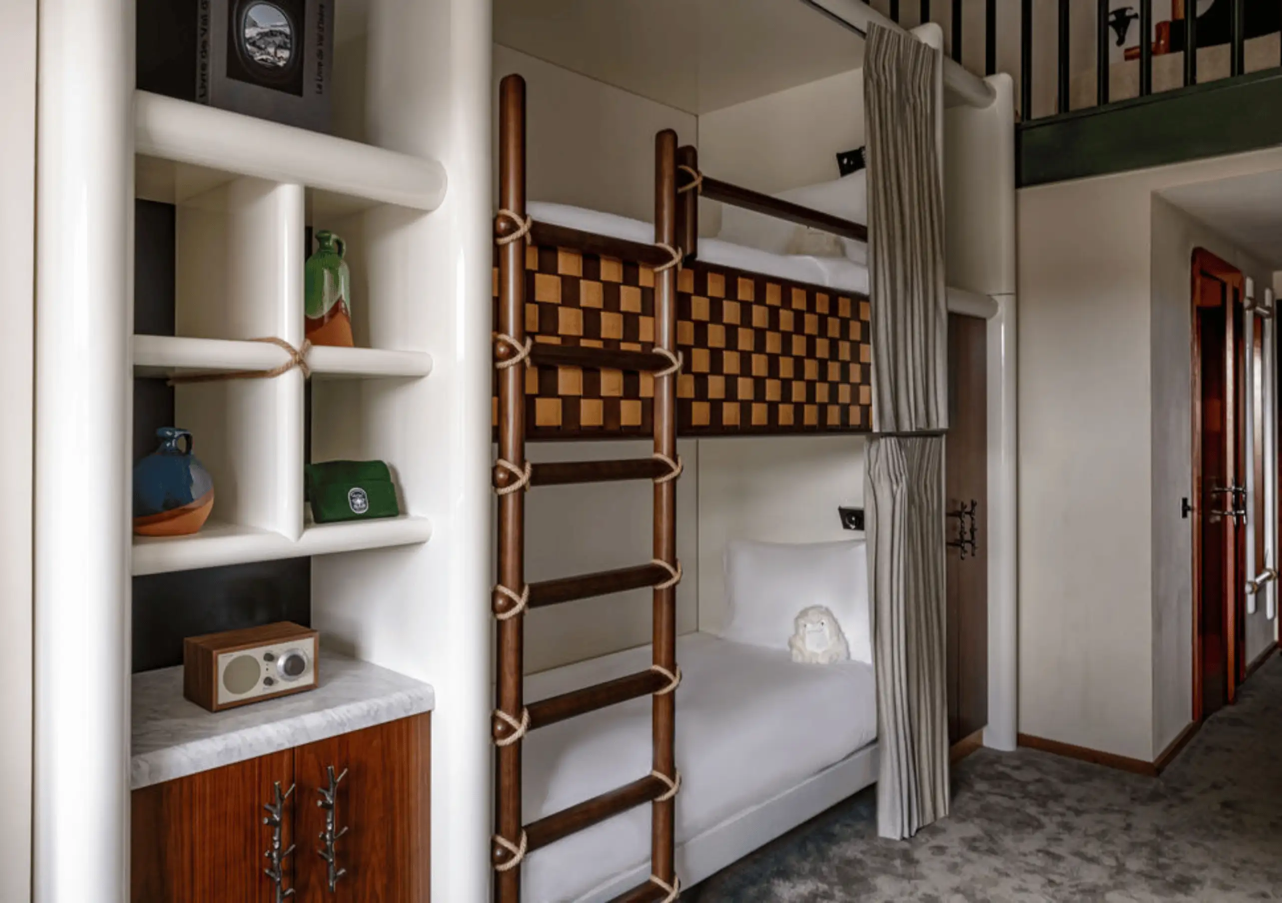 Wooden bunk beds with a ladder and built-in shelving in the Loft Mezzanine Bunk Beds at Experimental Chalet Val d'Isère