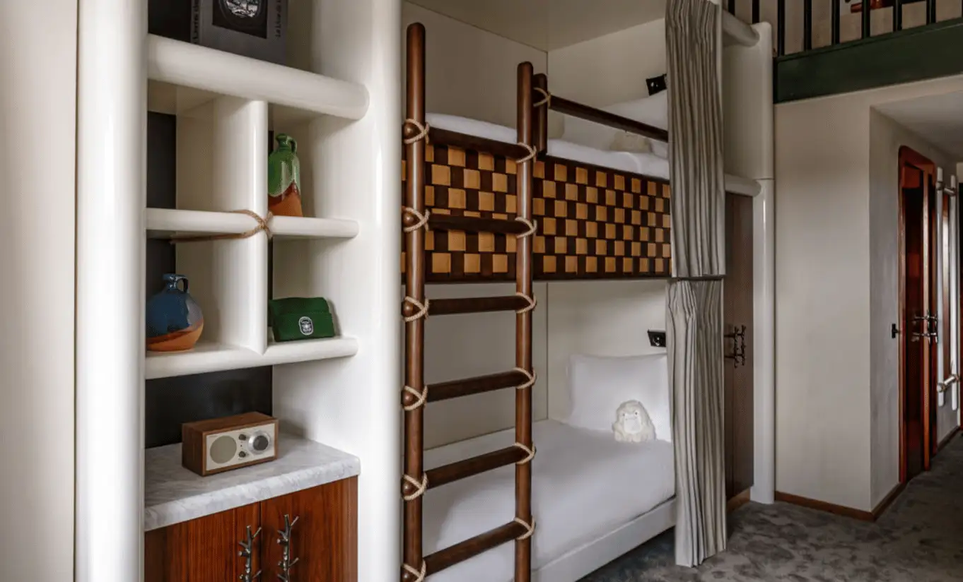 Wooden bunk beds with a ladder and built-in shelving in the Loft Mezzanine Bunk Beds at Experimental Chalet Val d'Isère