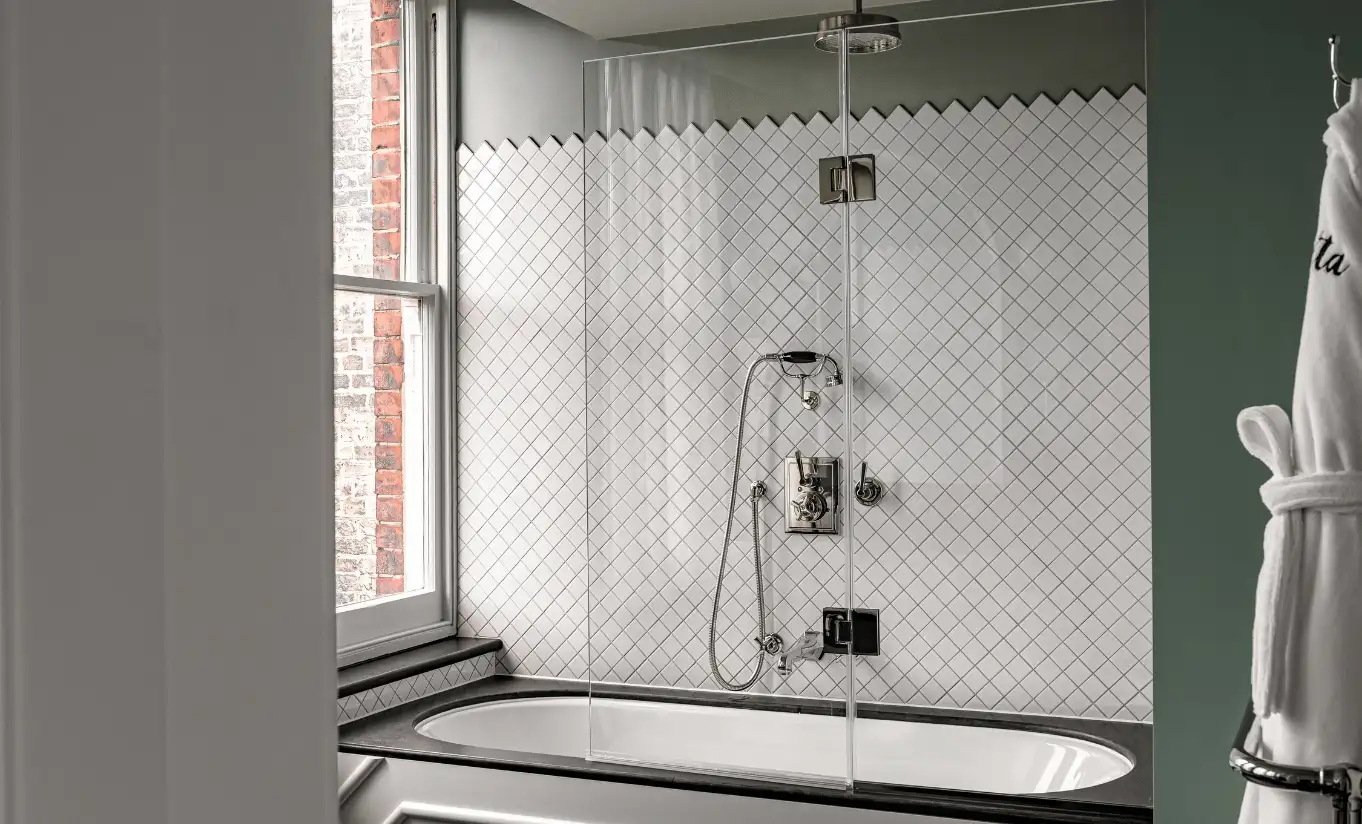 Bathroom with a walk-in shower, herringbone tiled walls and green accents in the Saint Paul Executive Room at Henrietta Experimental, boutique hotel in Covent Garden