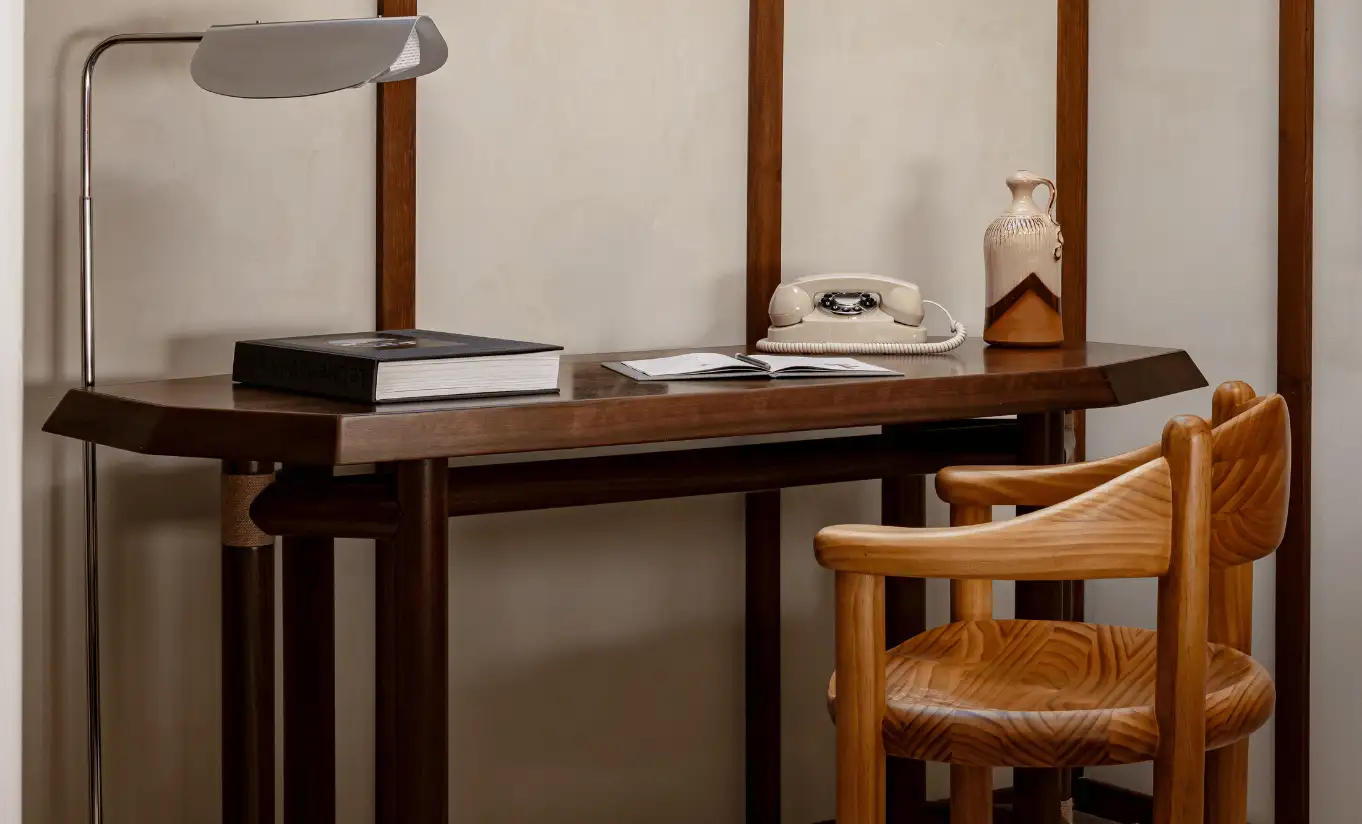 Wooden desk and chair by a wall lamp in the Bellevarde Suite at Experimental Chalet Val d'Isère, boutique hotel in Val d'Isère