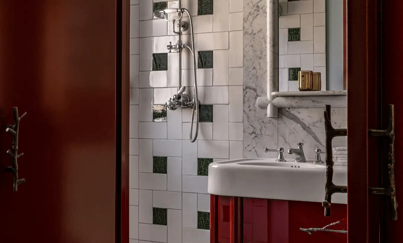 Bathroom with geometric black and white tiles, a red vanity unit and a walk-in shower in the Loft at Experimental Chalet Val d'Isère