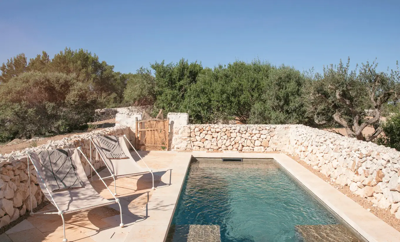 Menorca Experimental, private stone-walled pool surrounded by Mediterranean olive trees and natural landscape, Experimental Group.