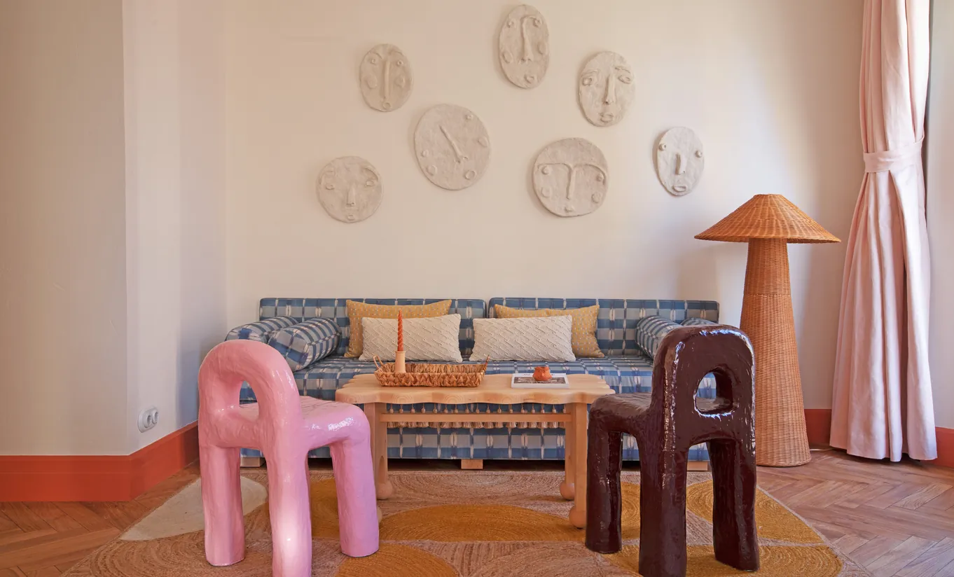 Playful lounge corner with a patterned upholstered sofa, decorative wall plates and two sculptural animal-shaped stools at Montesol Experimental hotel, Experimental Group.