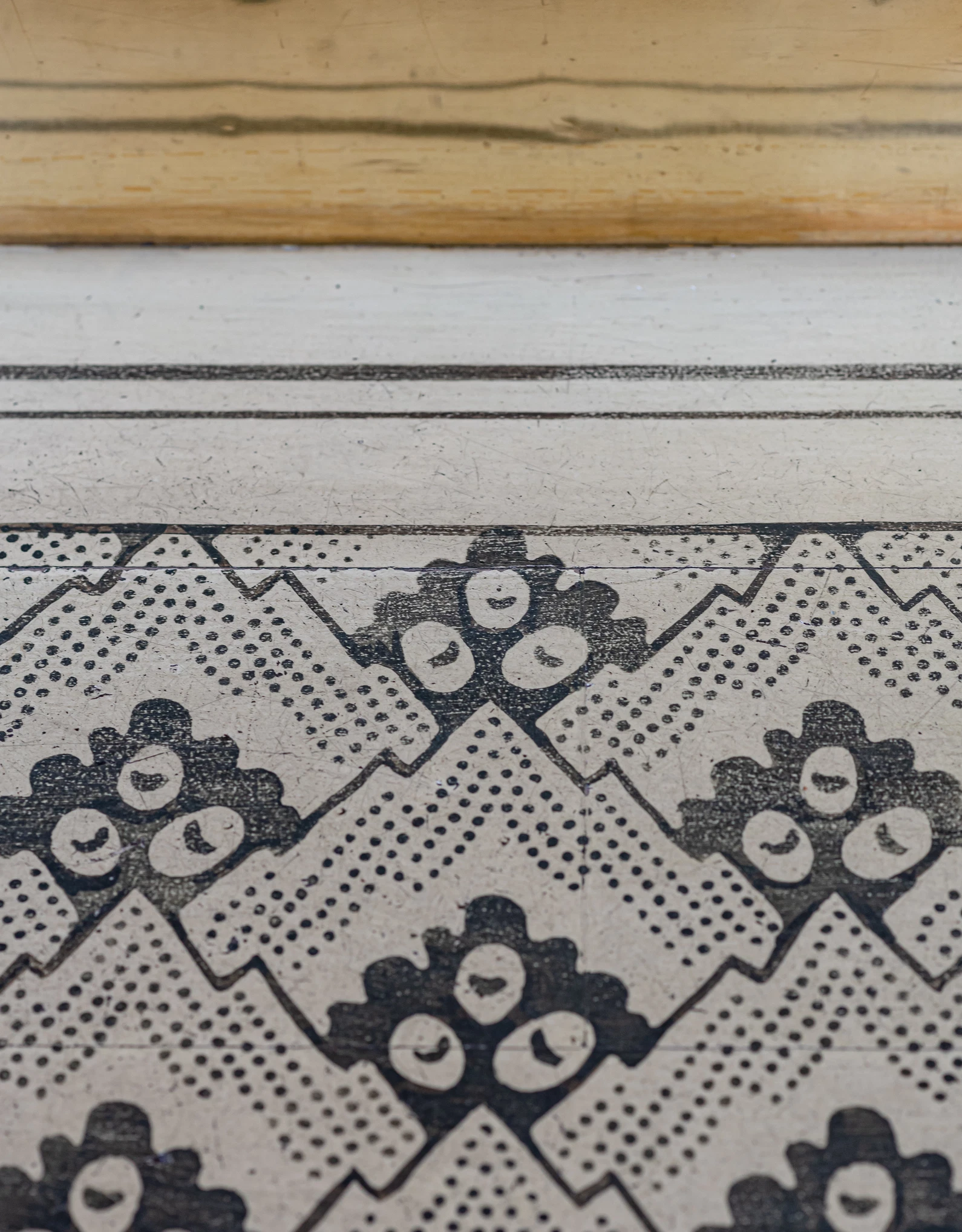 Detail of an intricate decorative pattern on a wall or textile, illustrating the attention to detail and singular design of the Experimental Group.