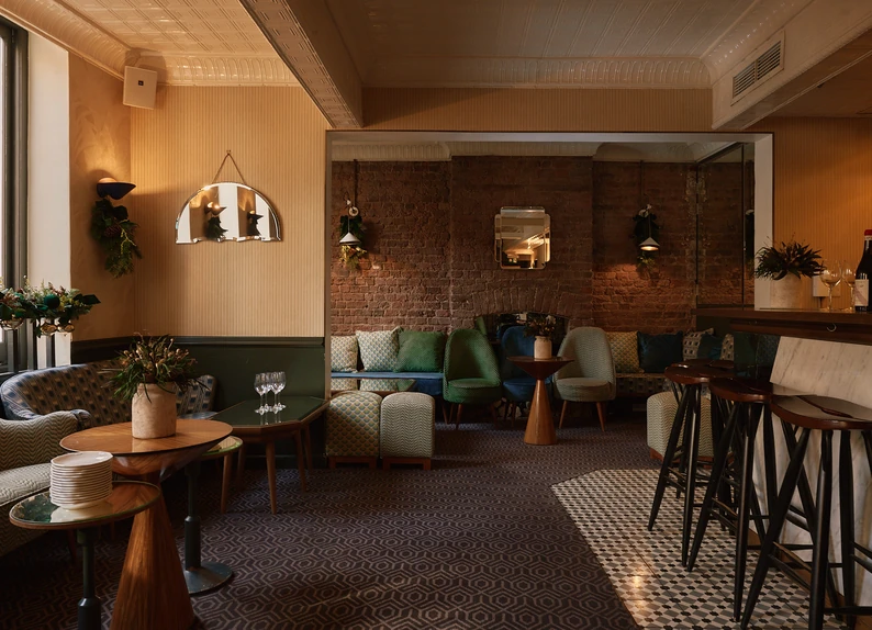 Cozy lounge with comfortable sofas and warm lighting at Experimental Group