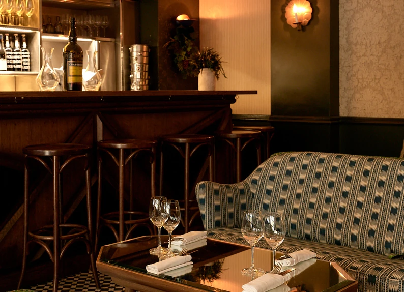 Classic wooden bar counter with wine glasses at Experimental Group