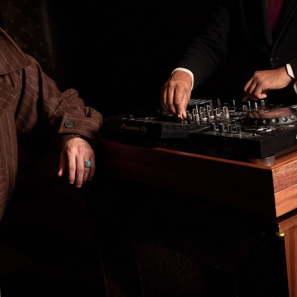 DJ mixing music on professional equipment at an Experimental Group event.