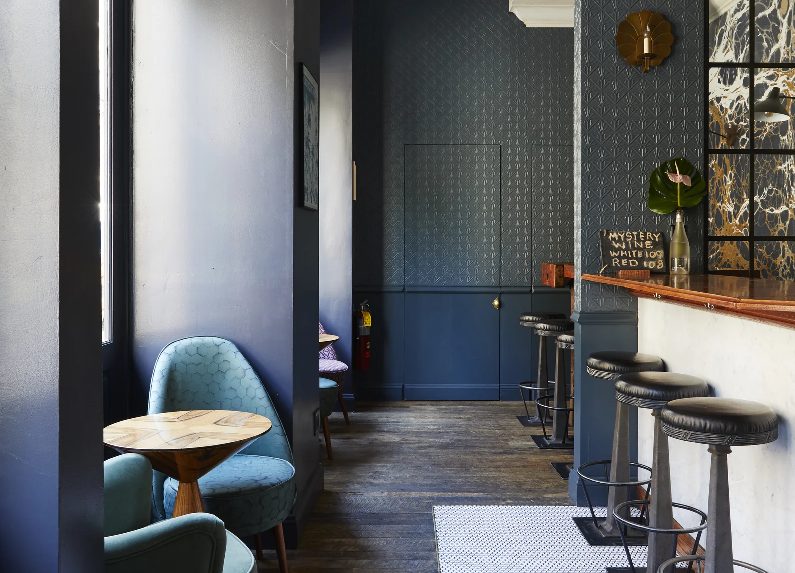 Modern bar with stools and deep blue armchairs at Experimental Group