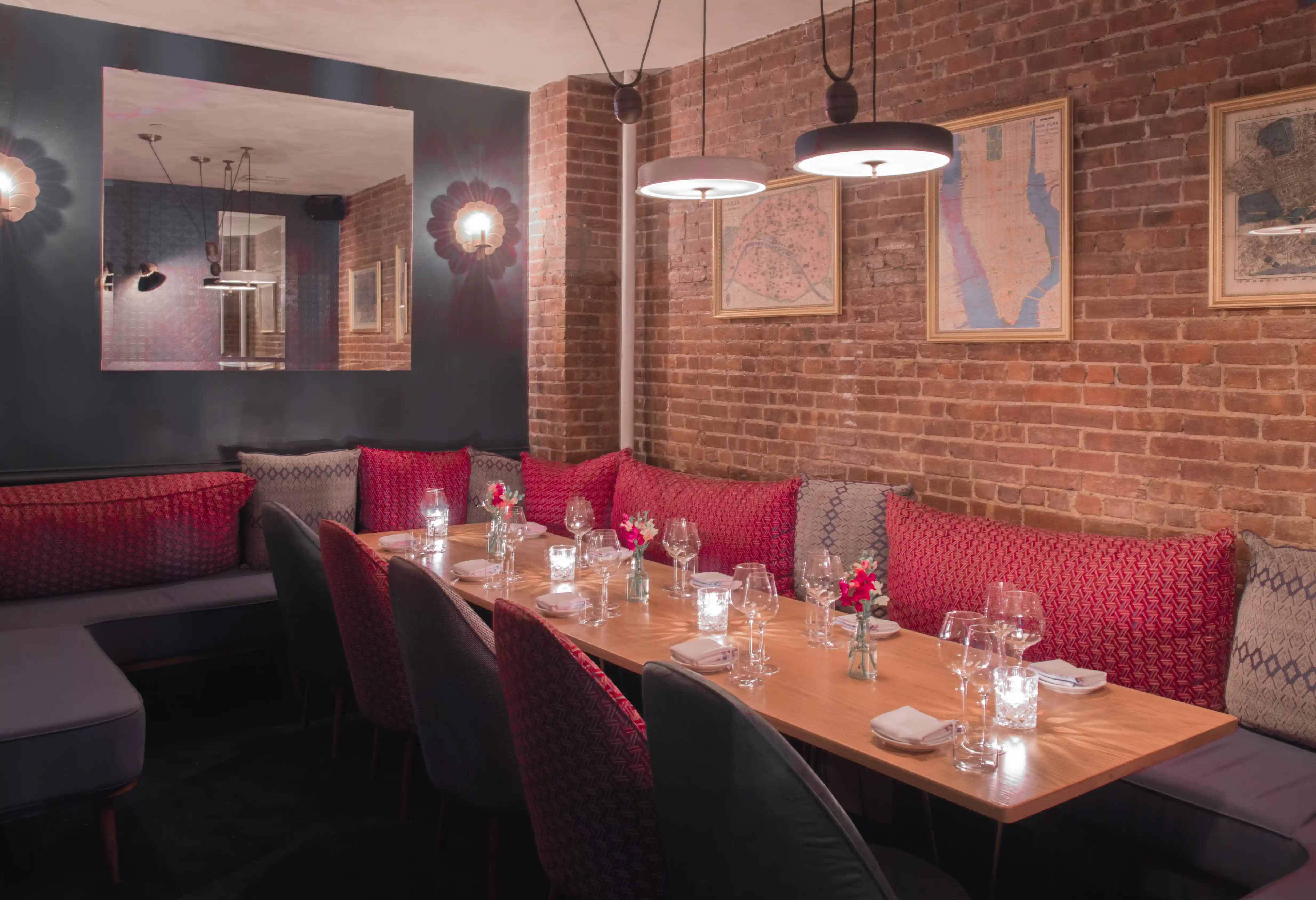 Elegant lounge area with brick wall and bottle display at Experimental Group
