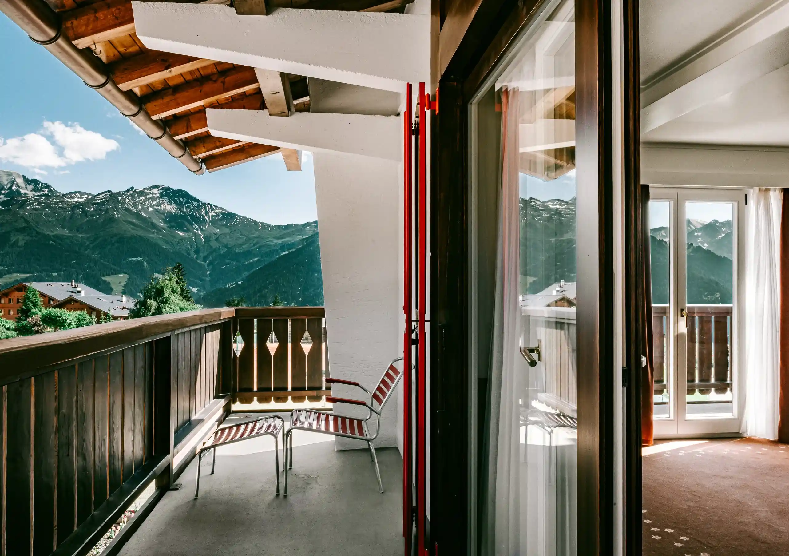 Varanda privada com cadeiras e vista para os Alpes Suíços no Quarto Deluxe com terraço do Experimental Chalet Verbier