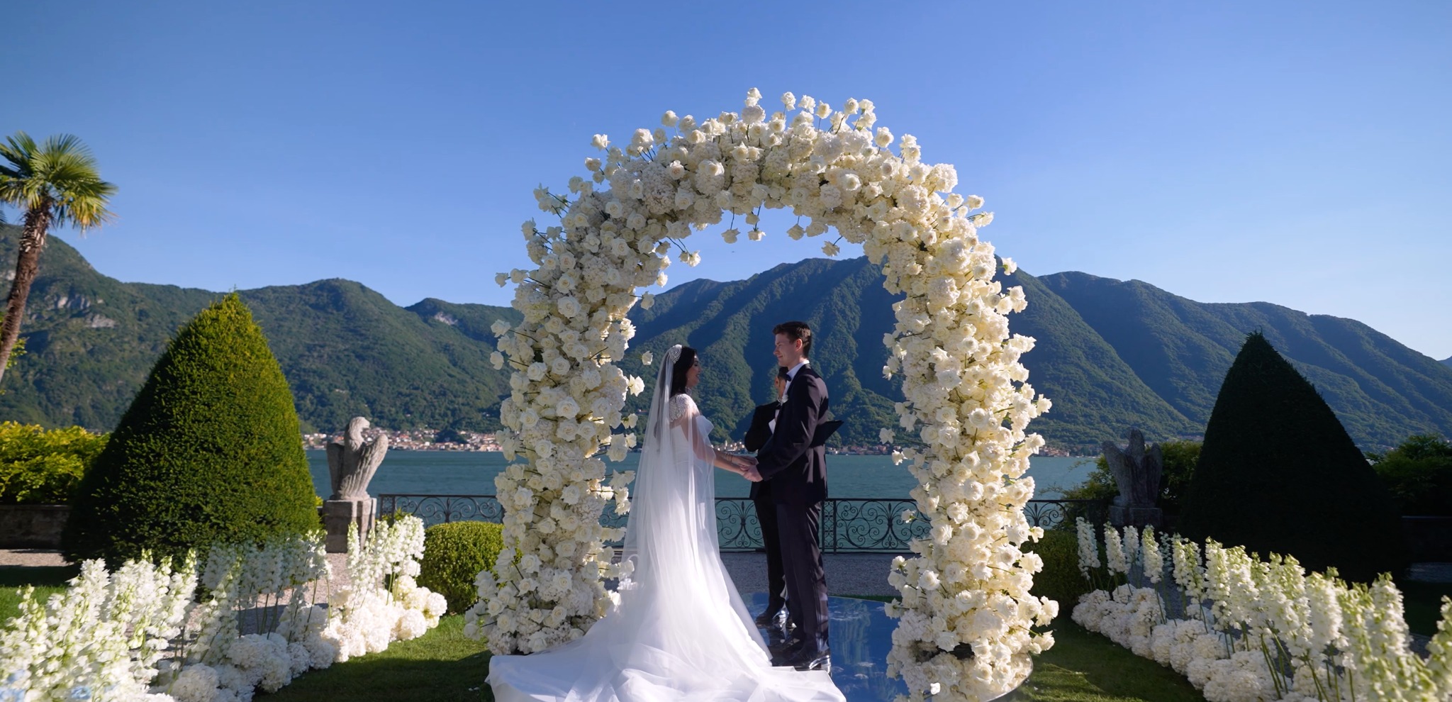 Lake Como wedding ceremony at Villa Balbiano with white floral arch