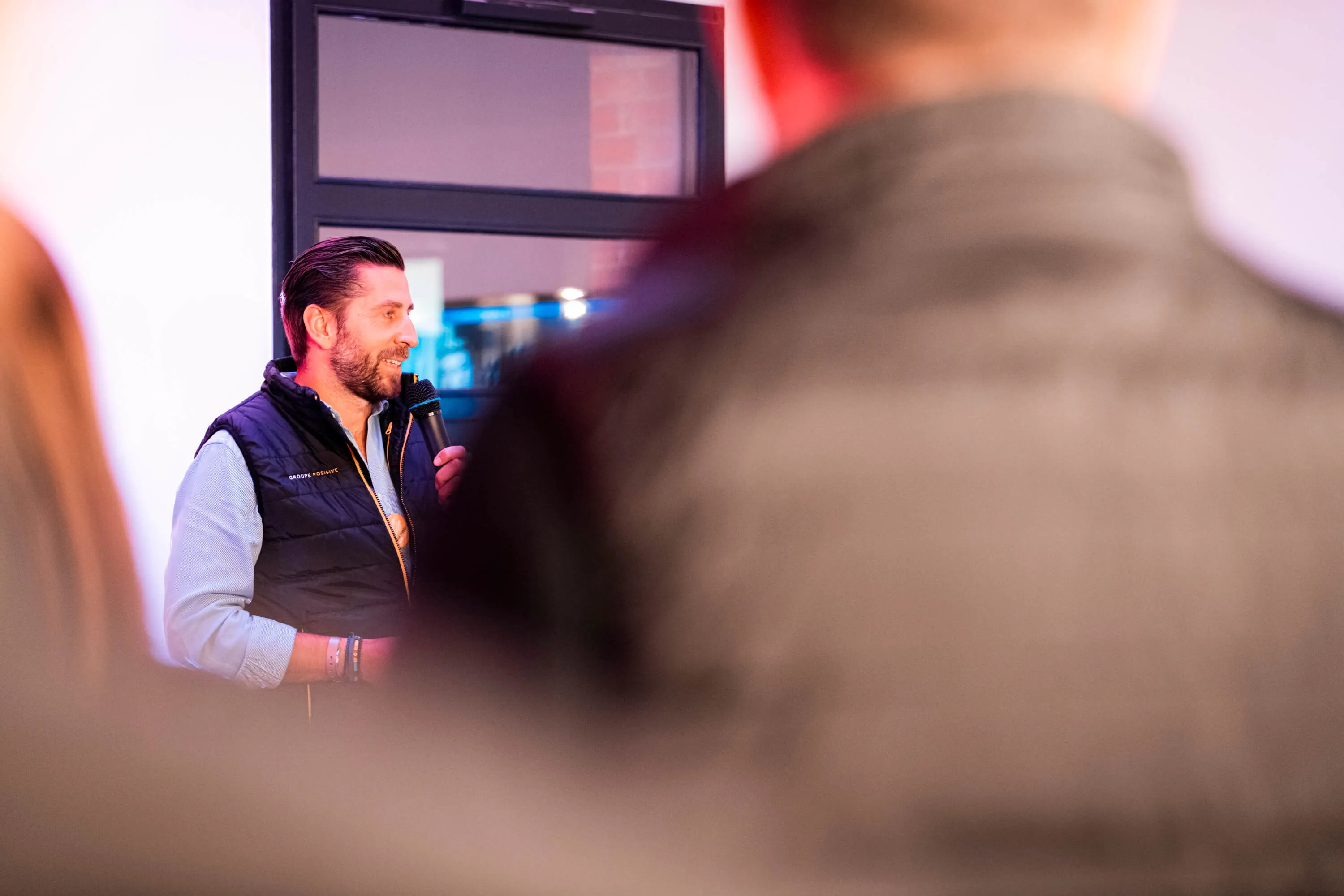 Mathieu Tarnus, founder and CEO of Positive group, speaking into a microphone during an event.