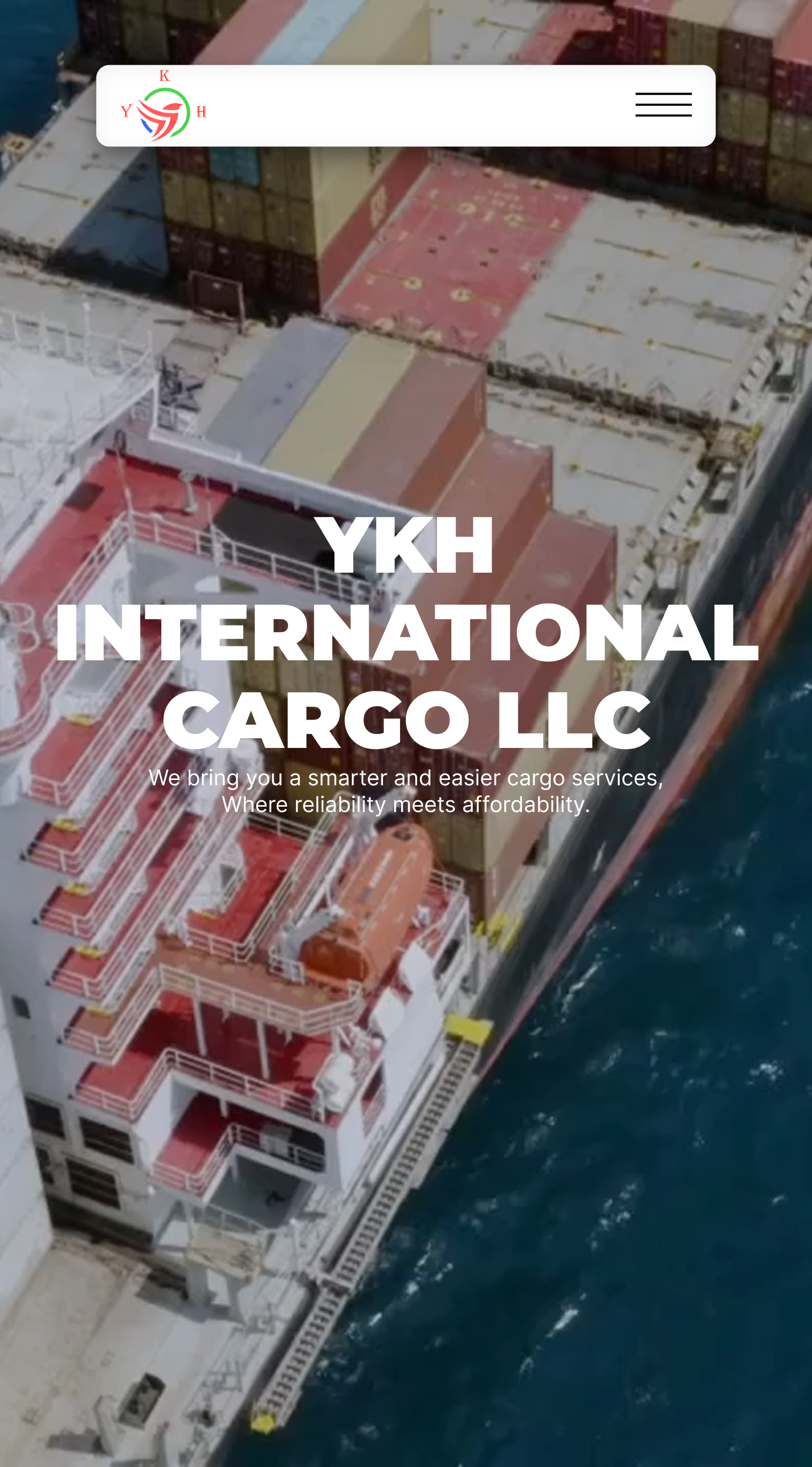 A cargo ship loaded with containers docked by the sea with YKH International Cargo LLC text overlay.