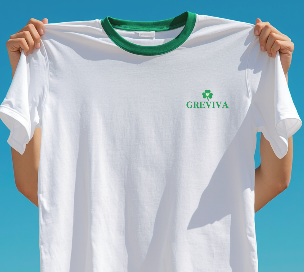 Person holding a white T-shirt with green collar and a green GREVIVA logo with a clover on chest.