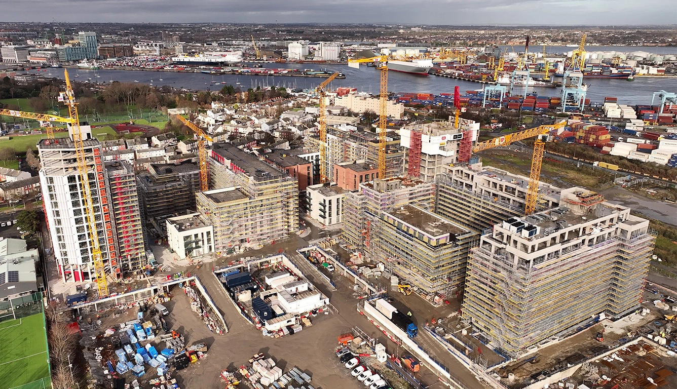 Aerial view of the Glass Bottle construction site in Dublin with multiple cranes and residential buildings under development.