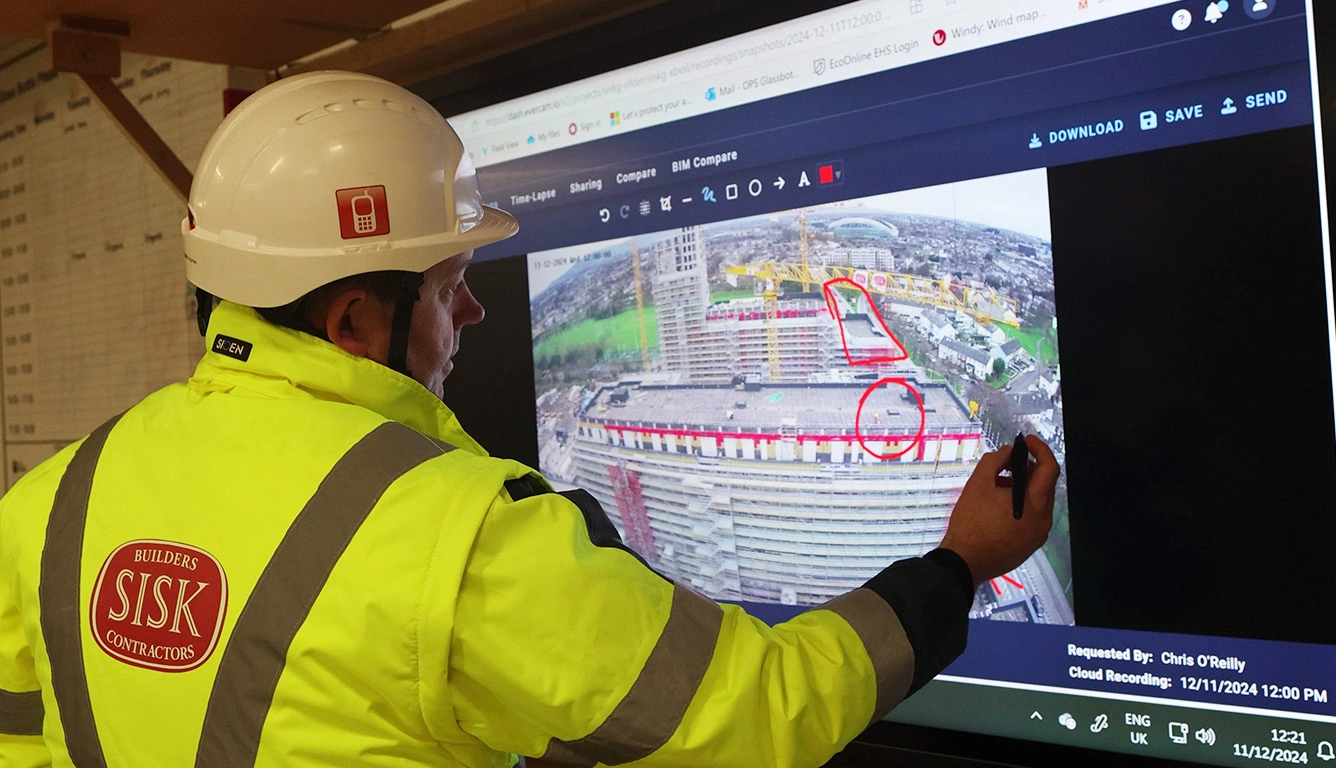 Construction professional using Evercam live camera footage to review site conditions and plan work safely.