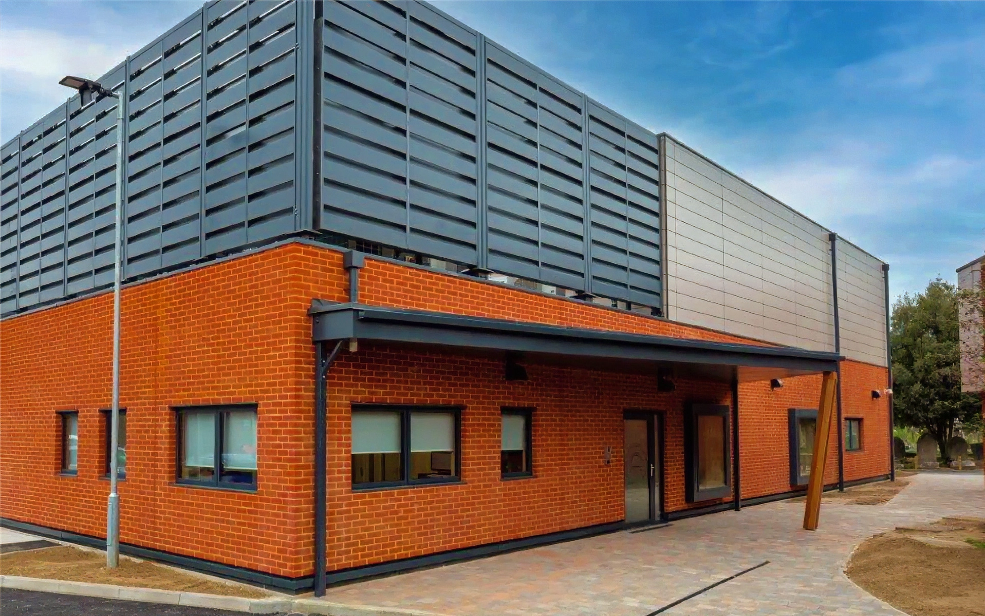 Exterior view of the completed East London Forensic Centre building with brick façade and secure design features.