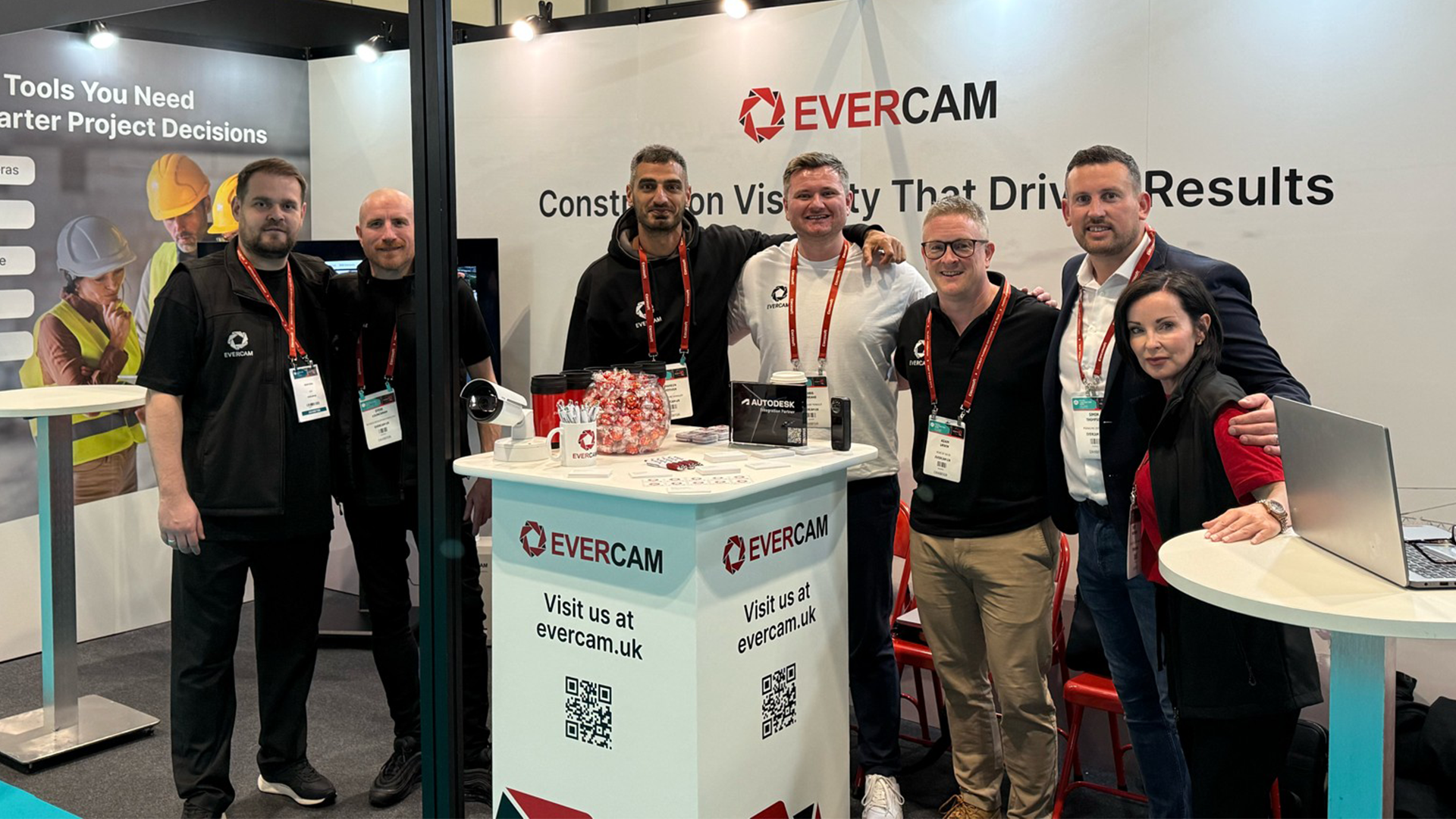 Evercam team members standing at an exhibition booth focused on construction visibility and site intelligence
