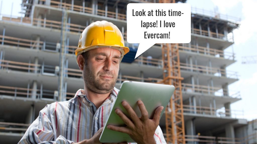 contruction worker holding a tablet watching evercam timelapse videos