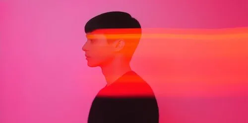 Profile of a person with short dark hair against a pink background with horizontal red light streaks crossing the image.