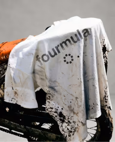 Bottle of Aurexon 4MLA Wash and a natural sponge by a window, framed by a person's bent arm and leg with visible dry skin.