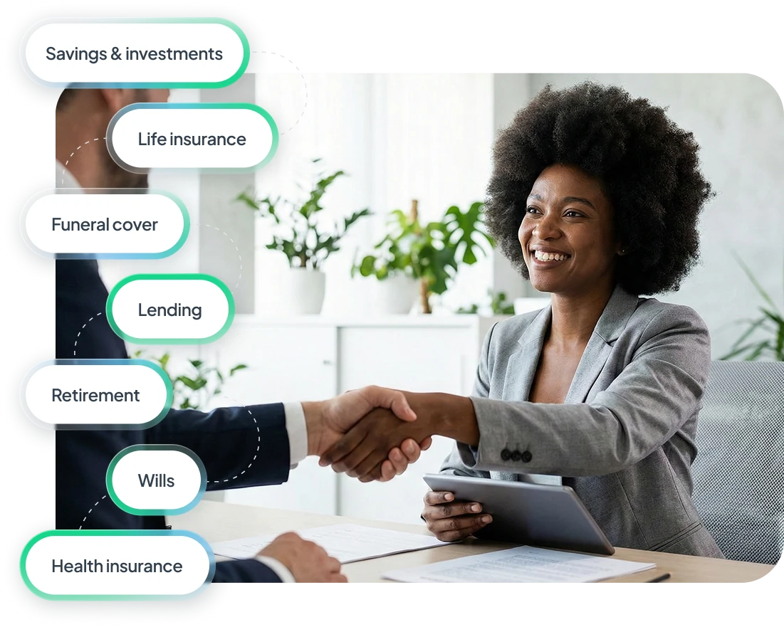 Smiling businesswoman in gray blazer shaking hands with a man across a desk in a bright office with plants, holding a tablet.